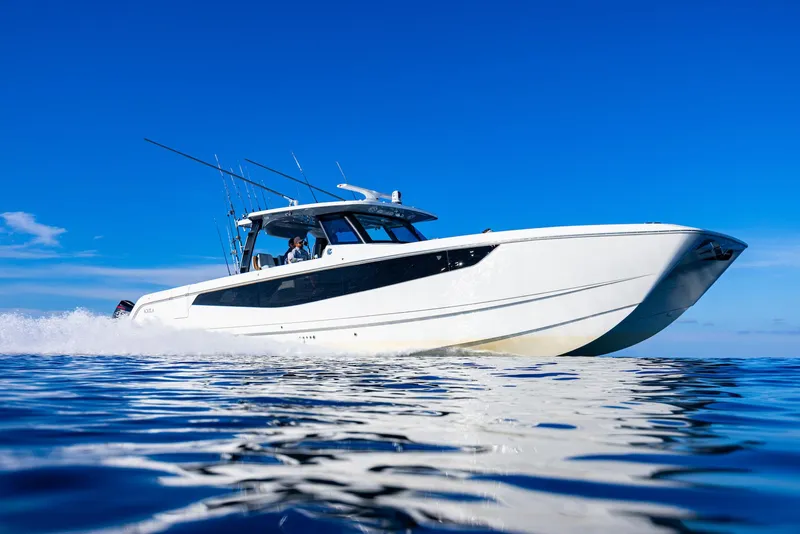 Slide: The Image of 2024 Aquila 47 Molokai cruising on open water under clear blue skies. - 5