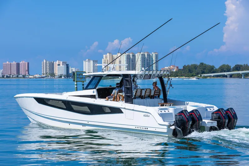 Slide: The Image of 2024 Aquila 47 Molokai boat cruising near city skyline. - 9