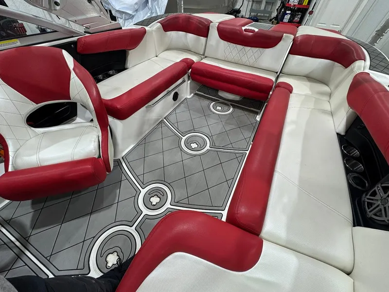 Slide: The Image of 2013 MasterCraft X30 boat interior with red and white seating and patterned flooring. - 12