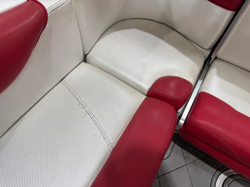 Slide: The Image of Red and white seating in 2013 MasterCraft X30 boat interior. - 13