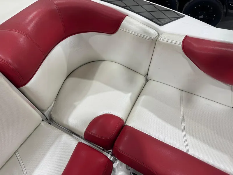 Slide: The Image of Red and white seating in 2013 MasterCraft X30 boat interior. - 14