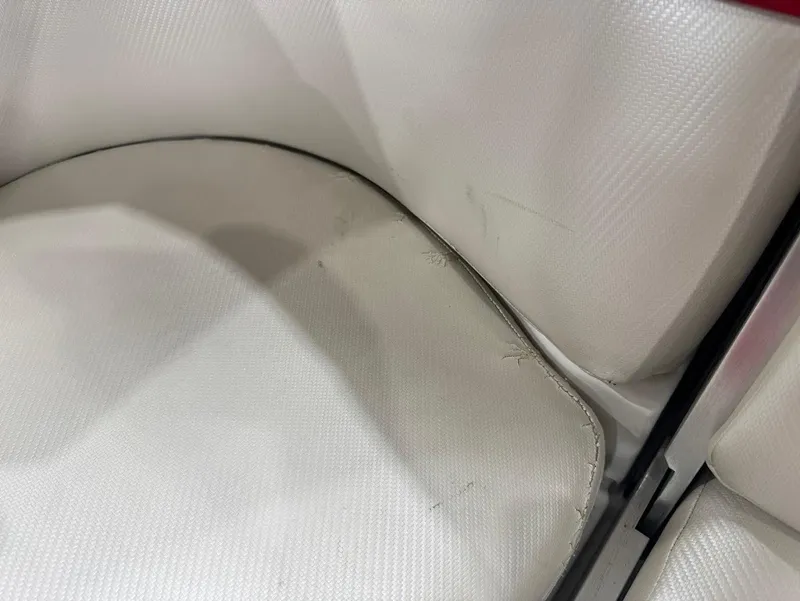 Slide: The Image of Close-up of worn white upholstery on a 2013 MasterCraft X30 boat seat. - 16