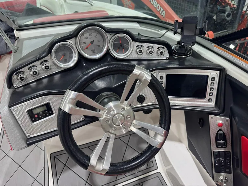 Slide: The Image of 2013 MasterCraft X30 dashboard with steering wheel, gauges, and control panel. - 17
