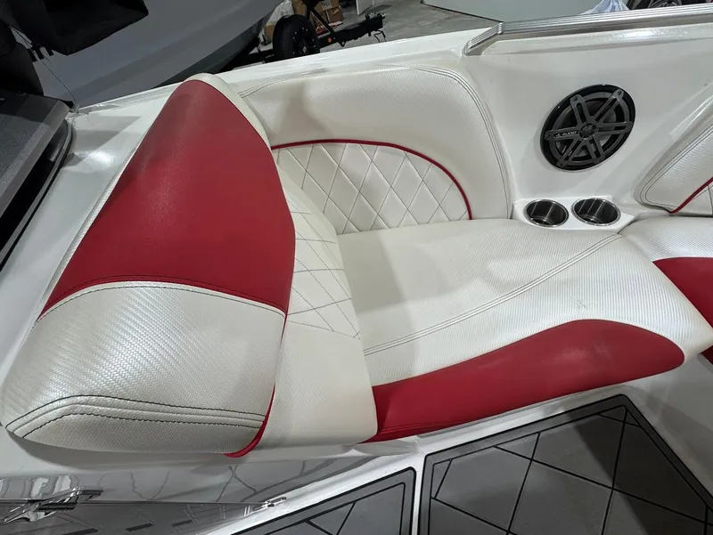 Slide: The Image of 2013 MasterCraft X30 boat interior with red and white leather seats and speaker. - 19