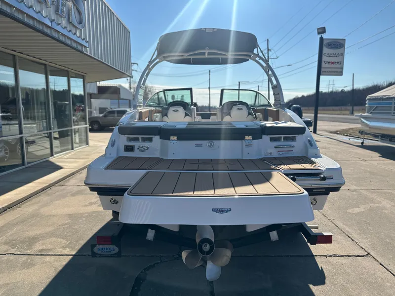 Slide: The Image of 2025 Chaparral 23 SSi boat, rear view, parked outdoors on a sunny day. - 3