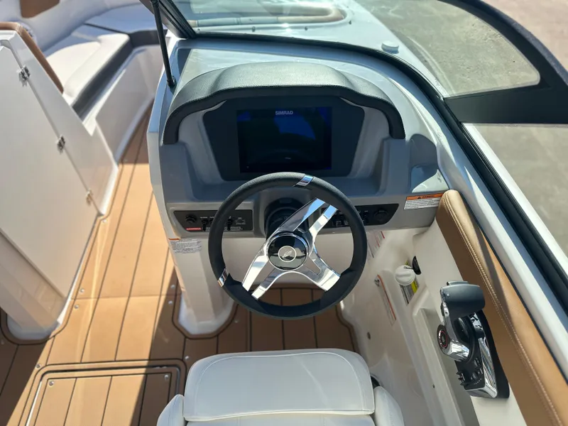 Slide: The Image of 2025 Chaparral 23 SSi boat cockpit with modern steering and dashboard. - 5