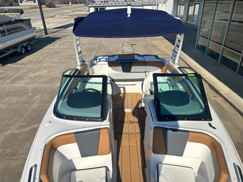Slide: The Image of 2025 Chaparral 23 SSi boat with open cockpit and blue canopy. - 7