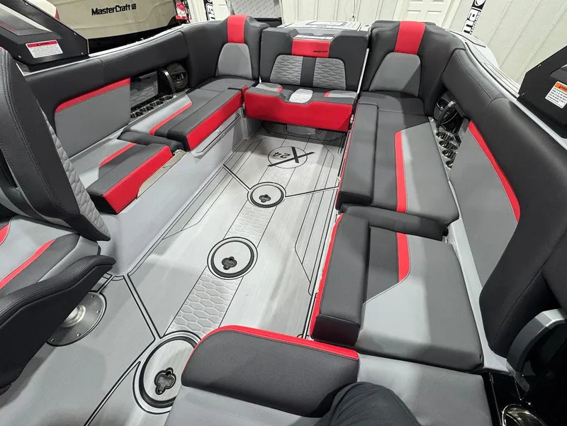 Slide: The Image of 2025 MasterCraft X24 boat interior with gray and red seating, modern design. - 10