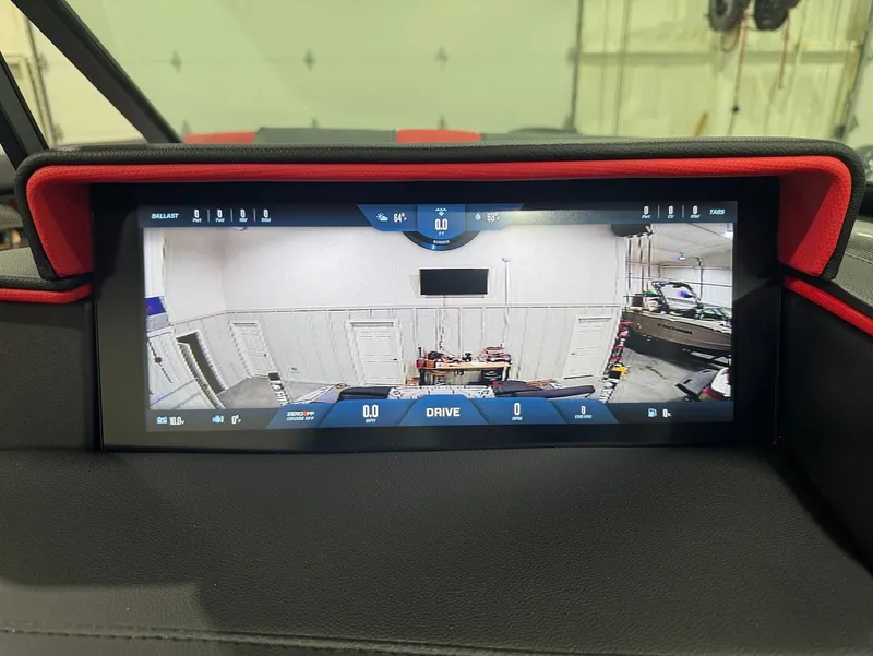 Slide: The Image of 2025 MasterCraft X24 dashboard display showing rearview camera in a garage setting. - 18