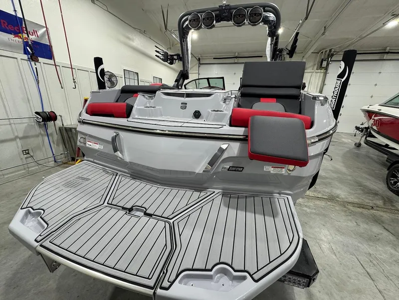 Slide: The Image of 2025 MasterCraft X24 boat in a garage, featuring a sleek design and spacious deck. - 4