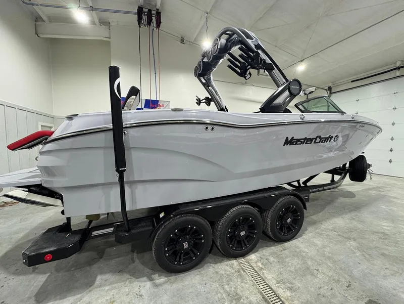 Slide: The Image of 2025 MasterCraft X24 boat on trailer in indoor storage. - 5