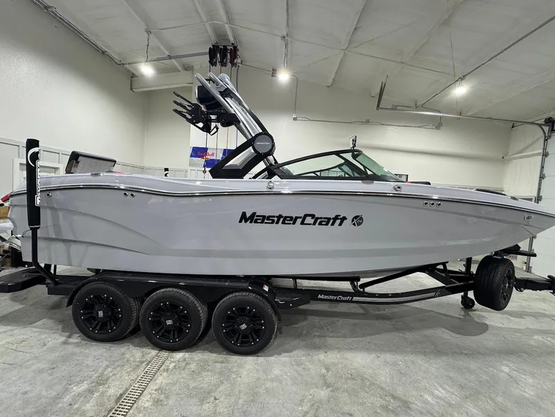 Slide: The Image of 2025 MasterCraft X24 boat on trailer in indoor showroom. - 6
