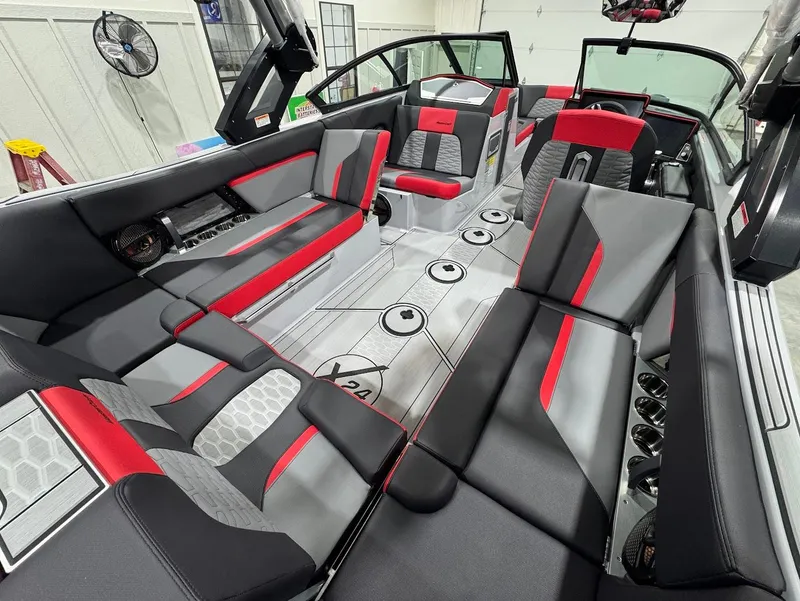 Slide: The Image of 2025 MasterCraft X24 boat interior with red and gray seating, modern design. - 8