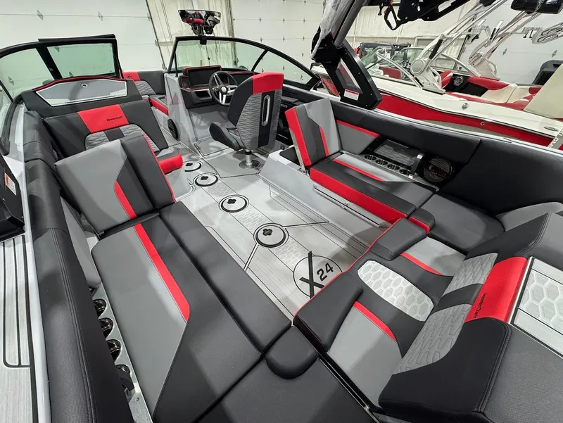 Slide: The Image of 2025 MasterCraft X24 boat interior with sleek red and gray seating design. - 9