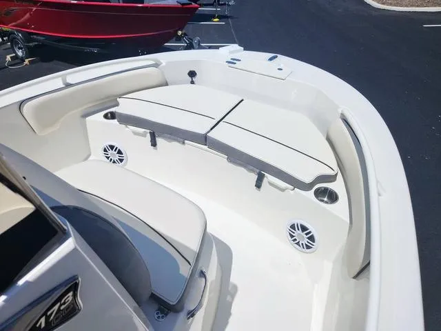 Slide: The Image of 2023 Stingray 173 CC boat interior with cushioned seating and speakers. - 10