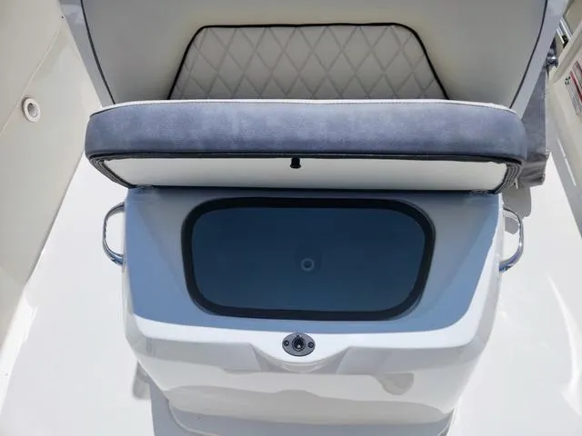 Slide: The Image of 2023 Stingray 173 CC boat seat with storage compartment open. - 14