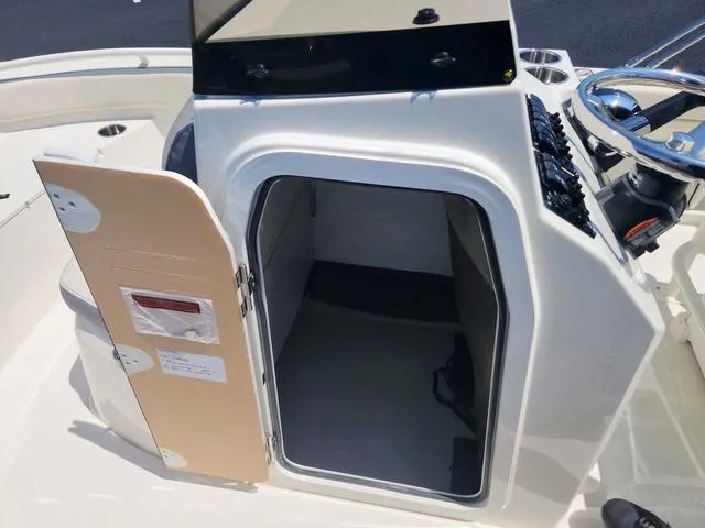 Slide: The Image of 2023 Stingray 173 CC boat console with open storage compartment. - 15