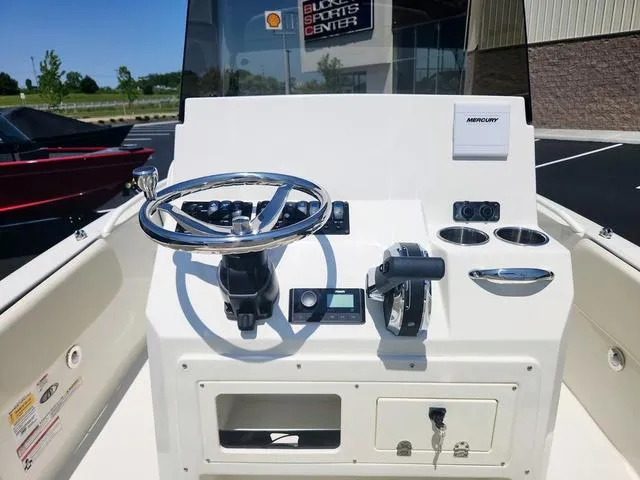 Slide: The Image of 2023 Stingray 173 CC boat console with steering wheel and controls. - 16