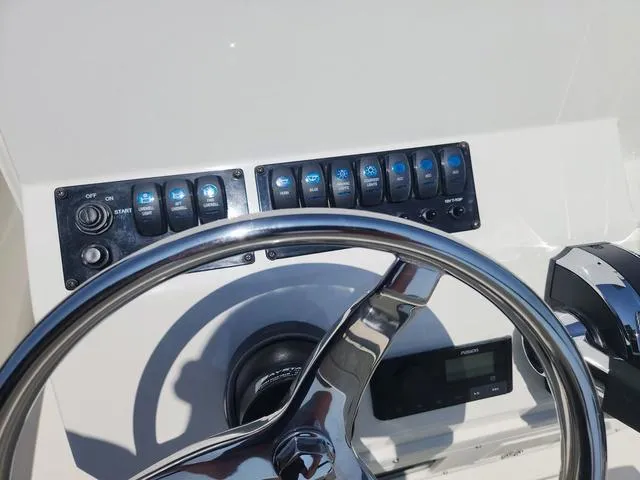 Slide: The Image of 2023 Stingray 173 CC boat dashboard with steering wheel and control panel. - 17