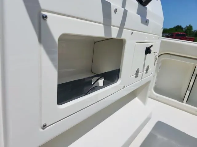 Slide: The Image of 2023 Stingray 173 CC boat interior storage compartment and control panel. - 18