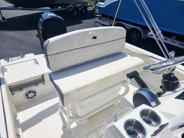 Slide: The Image of 2023 Stingray 173 CC boat interior with cushioned seating and steering console. - 19