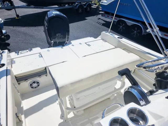 Slide: The Image of 2023 Stingray 173 CC boat interior with seating and motor, parked on a trailer. - 20