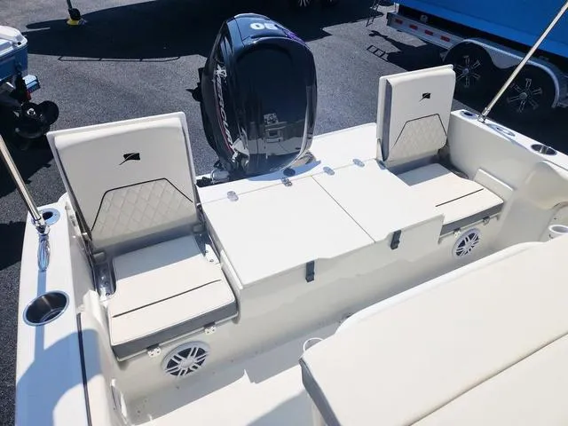 Slide: The Image of 2023 Stingray 173 CC boat interior with seating and motor, showcasing modern design. - 22