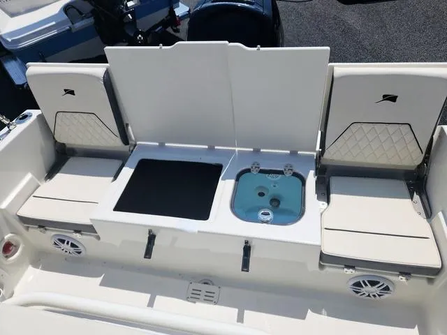 Slide: The Image of 2023 Stingray 173 CC boat interior with seating and storage compartments. - 23