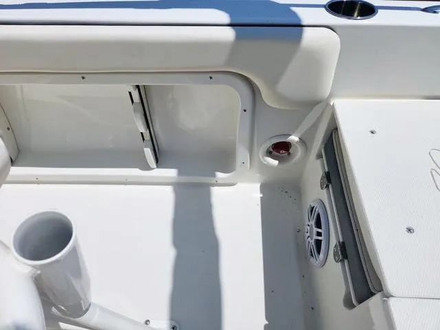Slide: The Image of 2023 Stingray 173 CC boat interior with storage compartment and speaker. - 24