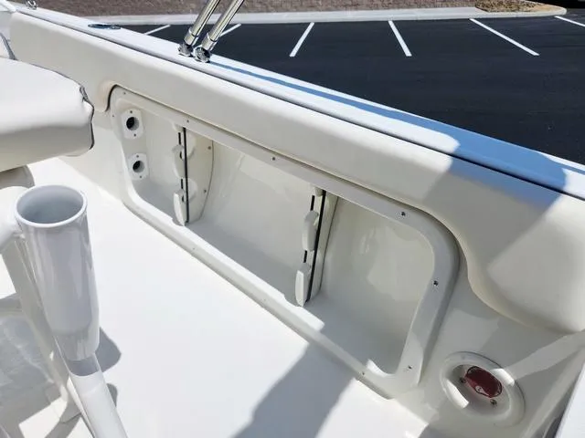 Slide: The Image of 2023 Stingray 173 CC boat interior detail with storage compartment and cup holder. - 25