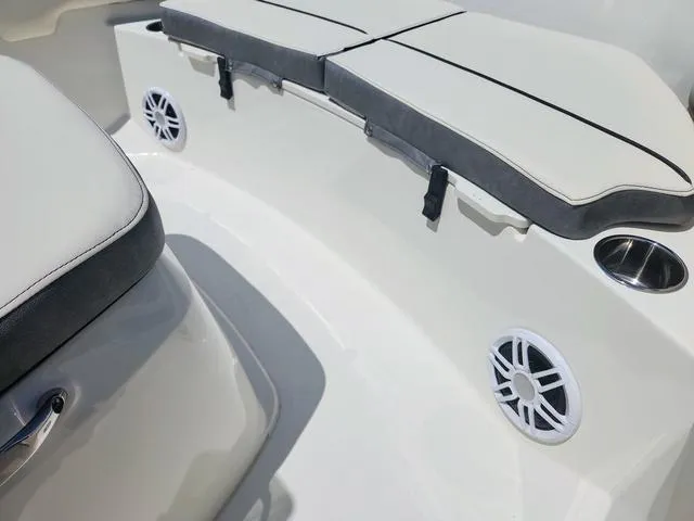 Slide: The Image of 2023 Stingray 173 CC boat interior with cushioned seating and built-in speakers. - 28