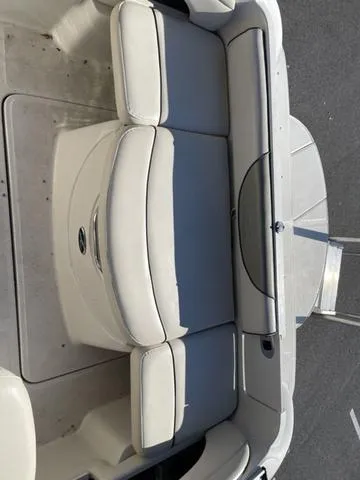 Slide: The Image of 2005 Sea Ray 225 Weekender boat seating area with gray cushions. - 10