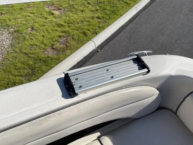 Slide: The Image of 2005 Sea Ray 225 Weekender boat interior with seating and metal fixture. - 12