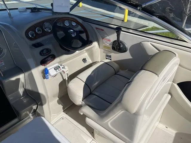 Slide: The Image of 2005 Sea Ray 225 Weekender boat cockpit with steering wheel and control panel. - 14