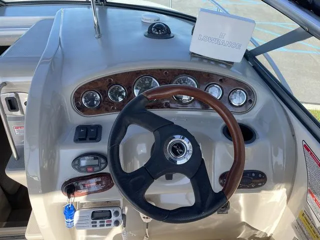 Slide: The Image of 2005 Sea Ray 225 Weekender boat dashboard with steering wheel and Lowrance navigation system. - 15