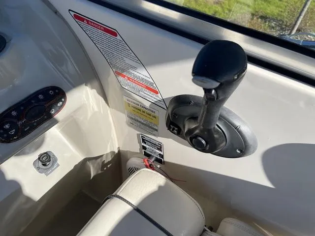 Slide: The Image of 2005 Sea Ray 225 Weekender boat controls and dashboard details. - 16