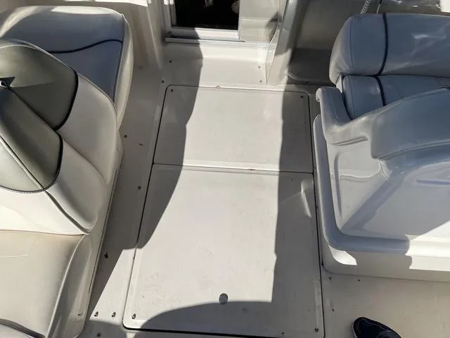 Slide: The Image of 2005 Sea Ray 225 Weekender boat interior with white seating and deck. - 17