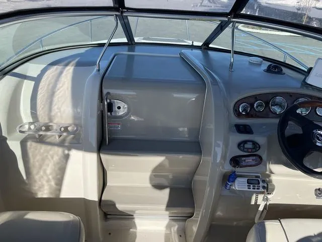 Slide: The Image of 2005 Sea Ray 225 Weekender boat cockpit with steering wheel and control panel. - 19