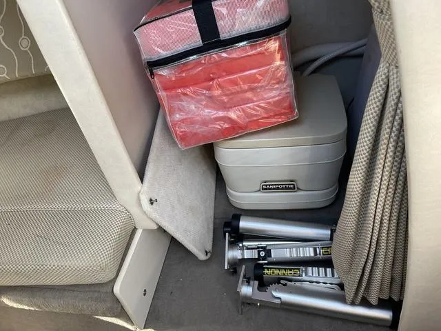 Slide: The Image of Storage area in 2005 Sea Ray 225 Weekender with portable toilet and equipment. - 21