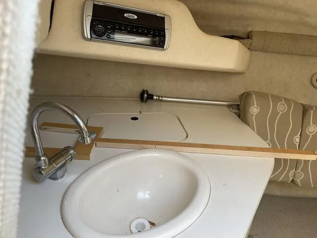 Slide: The Image of 2005 Sea Ray 225 Weekender cabin interior with sink and stereo system. - 22