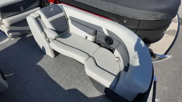 Slide: The Image of 2024 Barletta Cabrio C24UE boat interior with gray seating and speaker system. - 13