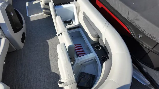 Slide: The Image of 2024 Barletta Cabrio C24UE boat interior with open storage compartment and seating. - 14