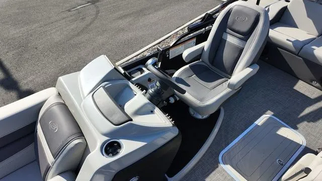 Slide: The Image of 2024 Barletta Cabrio C24UE boat interior with sleek captain's chair and modern dashboard. - 16
