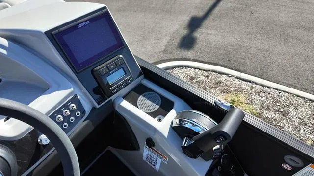 Slide: The Image of 2024 Barletta Cabrio C24UE boat dashboard with controls and display screen. - 17