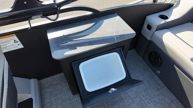 Slide: The Image of 2024 Barletta Cabrio C24UE boat interior with storage compartment and seating. - 19