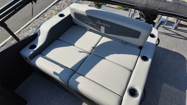 Slide: The Image of 2024 Barletta Cabrio C24UE boat seating with cup holders, featuring sleek gray upholstery. - 20