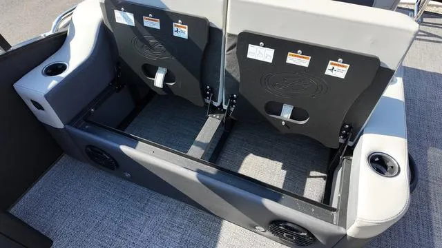 Slide: The Image of 2024 Barletta Cabrio C24UE boat seating area with storage and cup holders. - 21