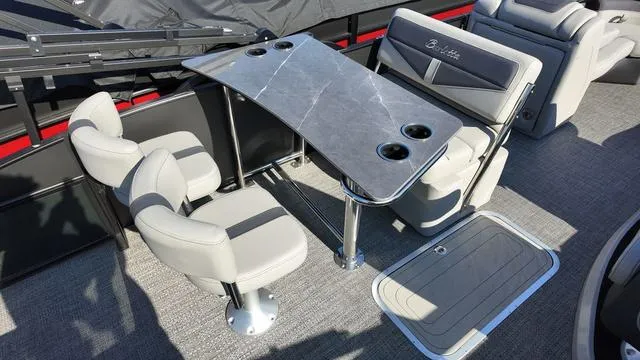 Slide: The Image of 2024 Barletta Cabrio C24UE boat interior with seating and table setup. - 24