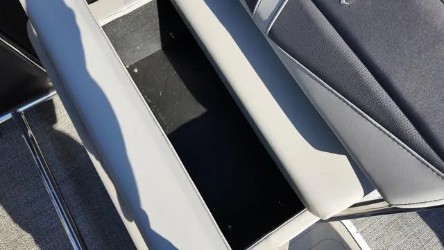 Slide: The Image of 2024 Barletta Cabrio C24UE boat seat storage compartment, gray upholstery. - 25