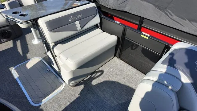Slide: The Image of 2024 Barletta Cabrio C24UE boat interior with gray seating and table. - 27